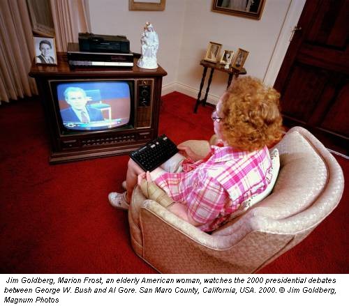 Jim Goldberg, Marion Frost, an elderly American woman, watches the 2000 presidential debates between George W. Bush and Al Gore. San Maro County, California, USA. 2000. © Jim Goldberg, Magnum Photos