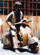 "Autoritratto in vespa" (2000) di Chris Gilmour (cartone, colla, cm 200 x 100)