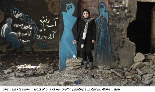 Shamsia Hassani in front of one of her graffiti paintings in Kabul, Afghanistan