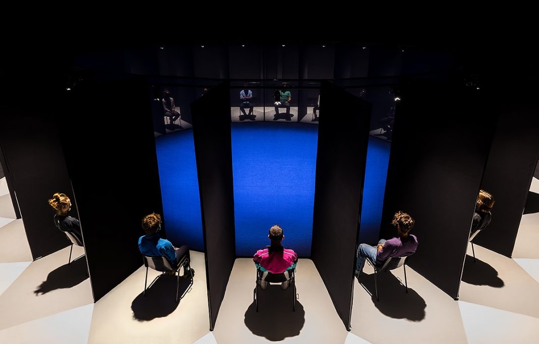 Panopticon con i visitatori-spettatori nelle postazioni singole separate da pannelli neri. Foto Serena Nicoletti_