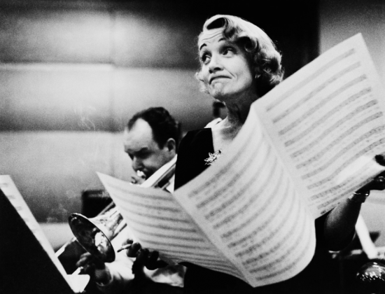 USA. New York City. Marlene Dietrich at the recording studios of COLUMBIA RECORDS, who were releasing most of her songs she had performed for the troops during World War II, including LILI MARLENE, Miss Otis Regrets.She was 51 years old and starting a come-back in show business.It was a wet and cold November night and work could only begin at midnight, at the advise of Marlene’s astrologer. November 1952.