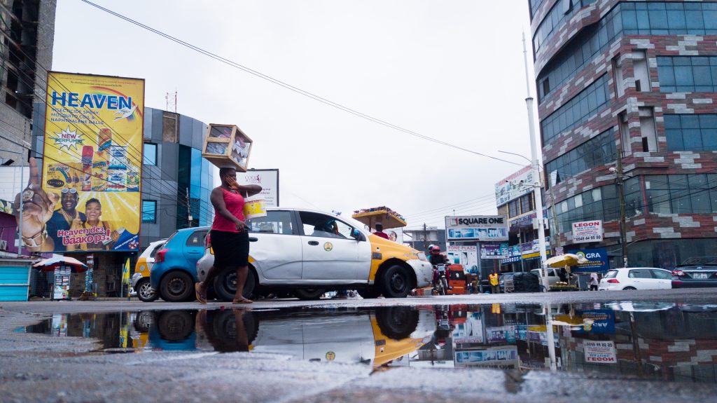 Woman dancing across puddles, Osu, Accra, Ghana Credit: Festus Jackson Davis