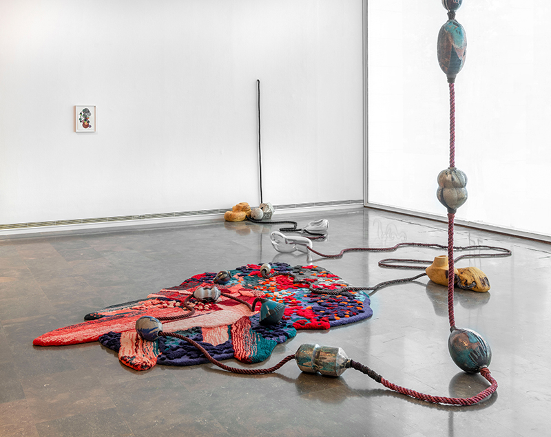 Otobong Nkanga (Nigerian/Belgian, b. 1974) Loaded tears turned to rock, 2023 Hand tufted carpet, Murano glass, wood, ceramic, clay, handmade rope, metal connectors Installation view of Craving for Southern Light at the IVAM Centre Julio González, 2023 Photo: IVAM Centre Julio González